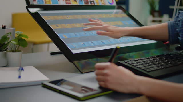 Close up of media specialist hands using graphic tablet