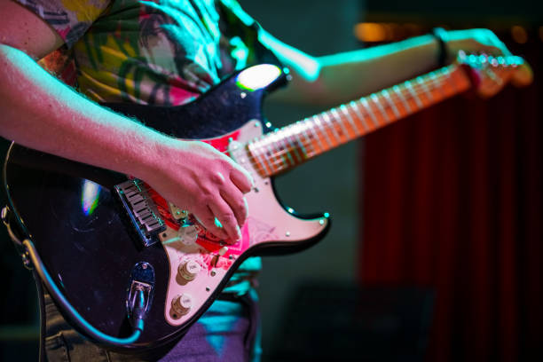 Musicians tuning the guitar on stage stock photo