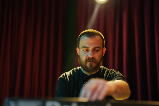 Musician playing keyboard on stage