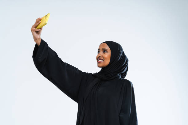 Beautiful arab middle-eastern woman with traditional abaya in studio