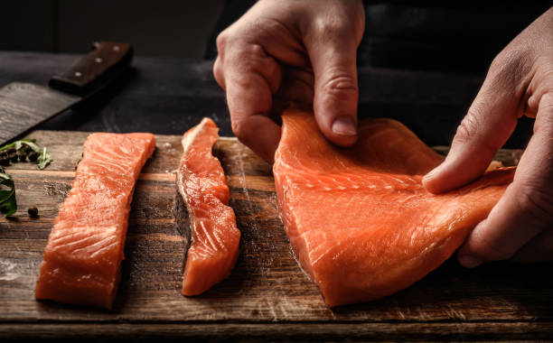 istock Chief cooking salmon red fish fillet in the kitchen 1494365919