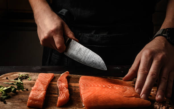 istock Mle cutting red Salmon fish on a cutting board 1494365928