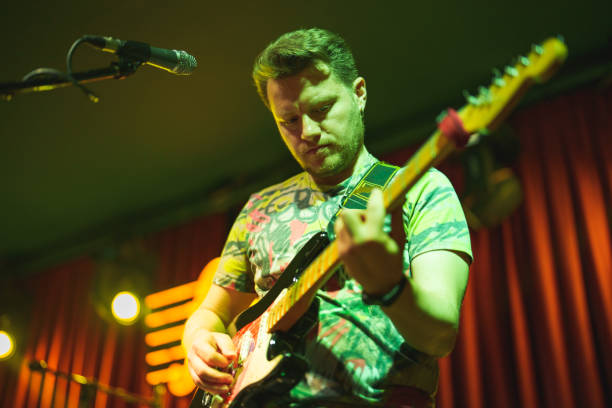 istock Musicians playing electric guitar and singing on stage 1494367712