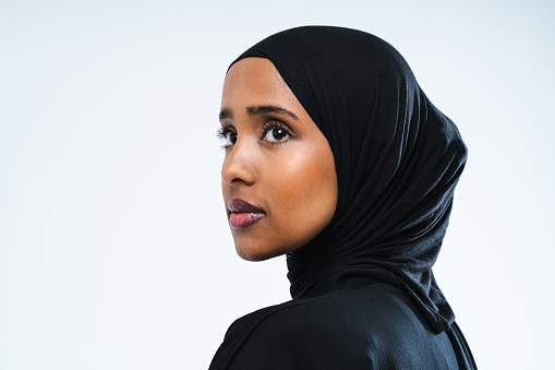 Beautiful arab middle-eastern woman with traditional abaya dress in studio - Arabic muslim adult female portrait in Dubai, United Arab Emirates