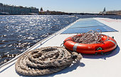 Nautical rope and red lifebuoy. Safety equipment of a passenger boat