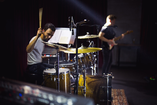 Musician plays drum on stage