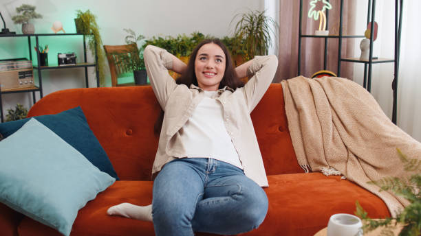 istock Tired lazy woman enjoy relaxing on home sofa resting napping after hard working day, closed her eyes 1494370471