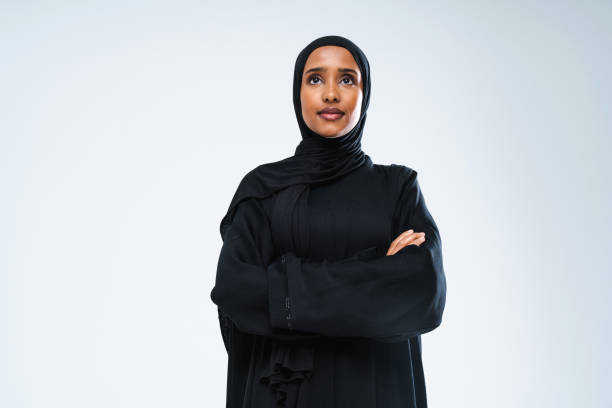Beautiful arab middle-eastern woman with traditional abaya in studio stock photo
