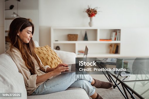 istock Remotely study, online lesson and gadget. Glad millennial european lady typing on computer 1494372025