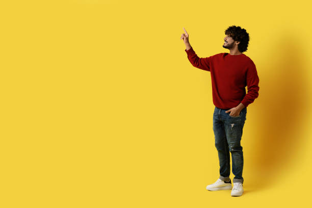 istock Excited indian man touching copy space on yellow 1494372685