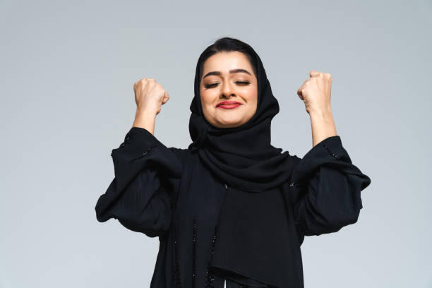 Beautiful arab middle-eastern woman with traditional abaya in studio stock photo