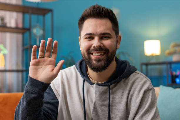 istock Caucasian man sitting on home couch, looking at camera, making video online webcam conference call 1494374521