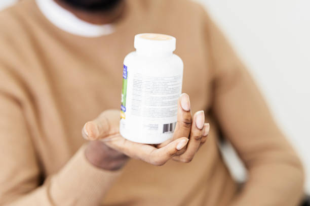 istock Middle Aged Black Man Holding a Bottle of Pills 1494376926