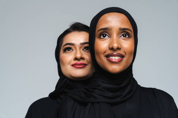 Beautiful arab middle-eastern women with traditional abaya in studio