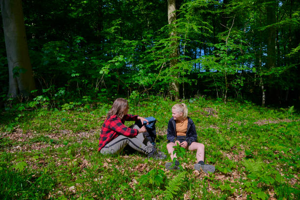istock Mother and Child sitting in forest floor 1494379605