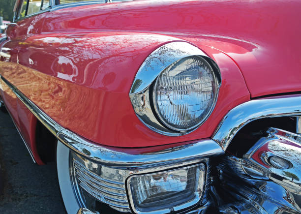 istock Large, Round Headlight with Chrome Eyebrow on Vintage Pink Car 1494381650