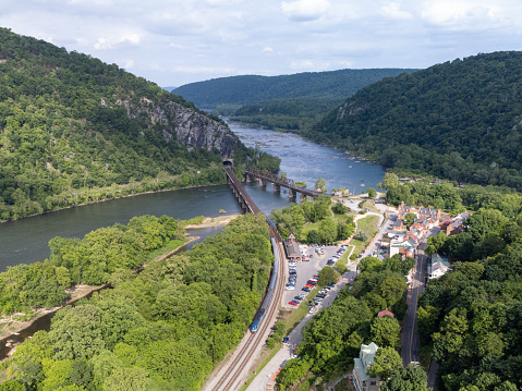 A aerial photo of downtown Harpers Ferry with a Amtrak Train stopped at the railroad station.