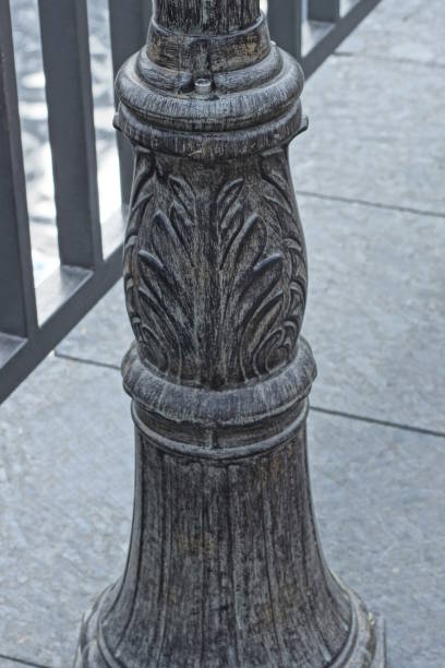 istock part of one black metal pole with a pattern stands on a gray sidewalk 1494389018