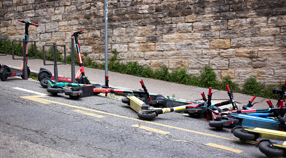 Lyon, France: Electric scooters strewn on a street in the Fourviere district near the cathedral.