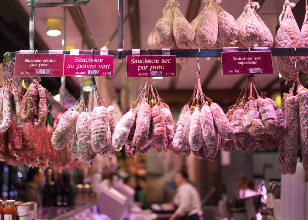 Lyon, France: Sausages hang in Les Halles de Lyon Paul Bocuse, a gourmet marketplace named after the famous chef from Lyon. The “rosette de Lyon” is the city’s most famous sausage.