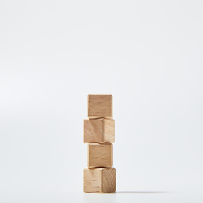 Four empty wooden cube blocks stack on white background with copy space, Mockup composition for design