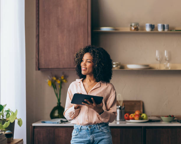 istock A Happy Beautiful Businesswoman Looking Away While Using Her Tablet 1494406558
