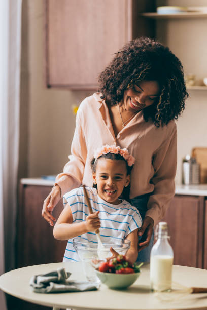 istock A Happy Beautiful Cute Child Looking At Camera While Mixing Ingredients For A Cake 1494406567
