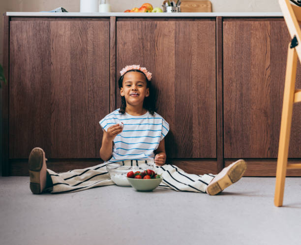 istock A Happy Beautiful Cute Child Looking At Camera While Eating Whipped Cream 1494406595