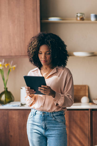 istock A Happy Beautiful Businesswoman Working From Home Using Her Tablet 1494406607