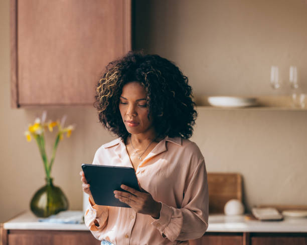 istock A Beautiful Businesswoman Working From Home Using Her Tablet 1494406608