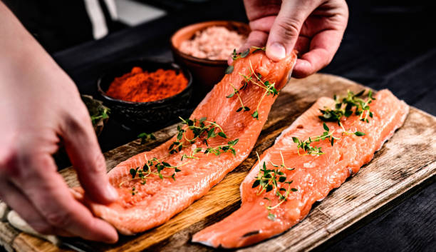 istock Chief cooking trout fillet for dinner fresh 1494413361