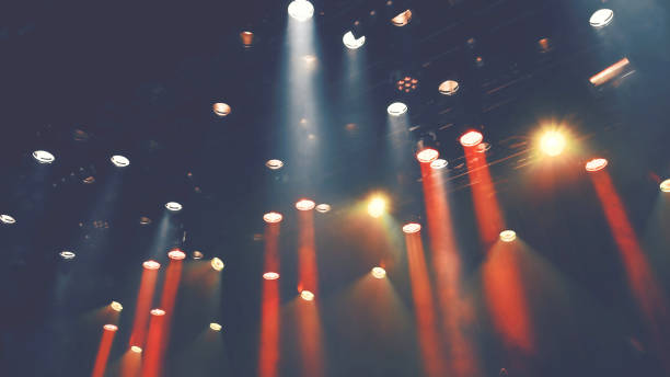 istock ceiling stage spotlights shines on a theater or Musical stage 1494414745