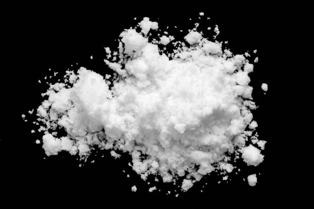 istock White snow isolated on black background close up 1494420489