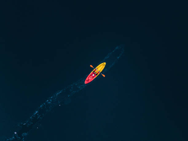istock People in nature. Kayaking in frozen lake. copy space 1494420588