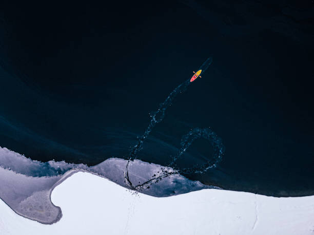istock People in nature. Kayaking in frozen lake. 1494420594