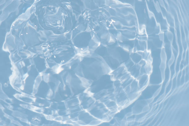 istock Blue water with ripples on the surface. Defocus blurred transparent blue colored clear calm water surface texture with splashes and bubbles. Water waves with shining pattern texture background. 1494424744