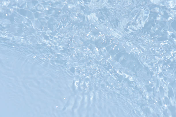 istock Blue water with ripples on the surface. Defocus blurred transparent blue colored clear calm water surface texture with splashes and bubbles. Water waves with shining pattern texture background. 1494424754