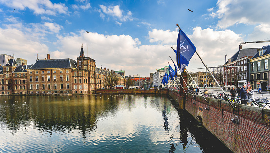 Hague, Netherland - 09 April 2023: Channel embankment in the center of Hague with a lot of flags of NATO North Atlantic Treaty organization