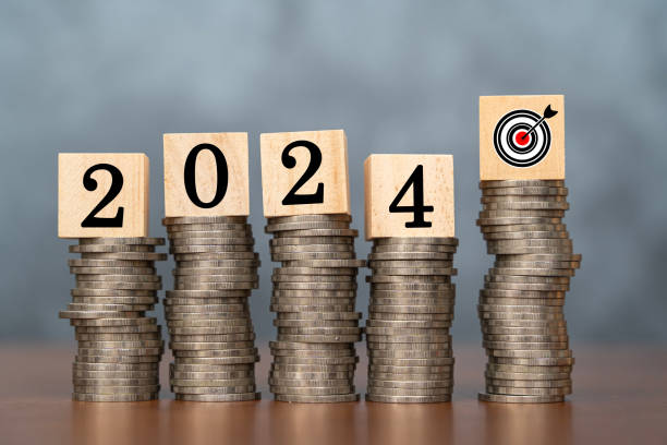 istock 2024 wooden cube and target on stack of coins with dark background and copy space. Money saving ideas and financial plans for investments. 1494437882