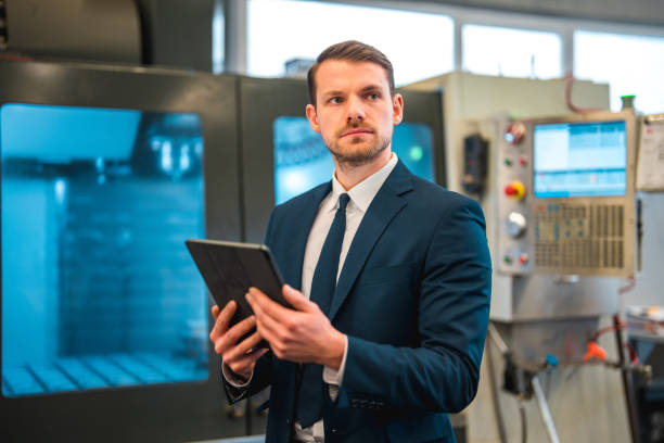 istock Handsome Young Caucasian Businessman Using Wireless Technology In A Factory 1494439476