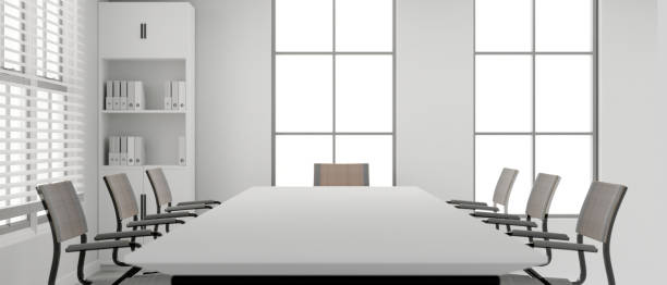 Front view of a modern white meeting room interior design with a large white meeting table