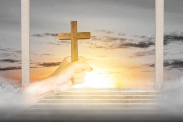 istock Human hand holding Christian cross 1494440441