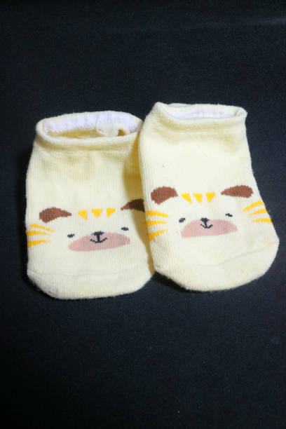 istock Cute baby socks yellow with a hamster face on them 1494442562
