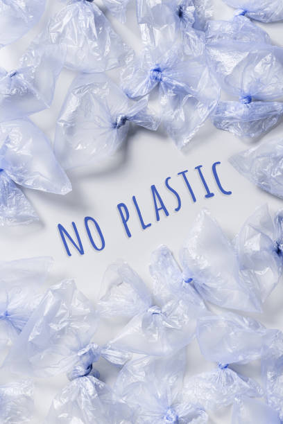 Used plastic bags and words No plastic, polyethylene packages on light background. Sustainable lifestyle, plastic free, eco trend to reduce disposable plastic, top view poster blue monochrome