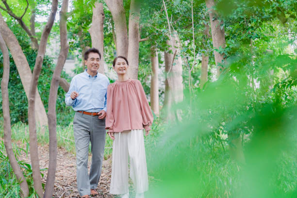 a senior couple taking a walk in nature - couple walking old middle imagens e fotografias de stock