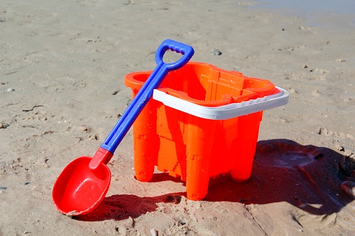 A colourful bucket and spade on a beach in Australia