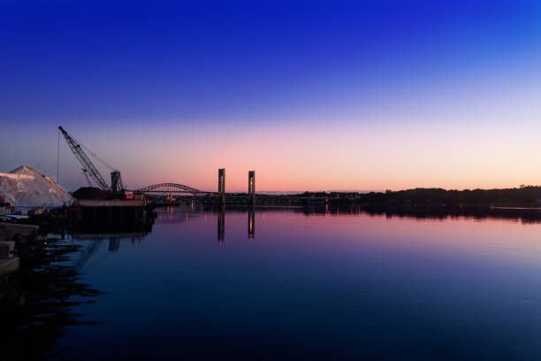 Pre-sunrise light over the Piscataqua River, bridges to Kittery, Maine,  and the huge salt pile (for winter de-icing), Portsmouth, New Hampshire
