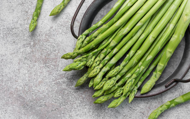istock Fresh green asparagus on  concrete background. 1494457006
