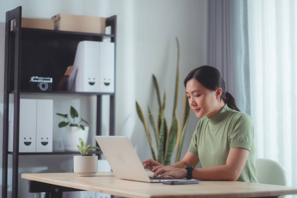 istock Asian woman enjoy with working online using laptop sitting at home office. 1494460230