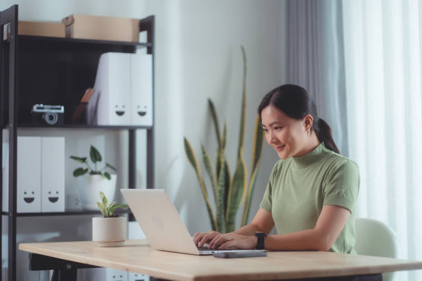 istock Asian woman enjoy with working online using laptop sitting at home office. 1494460244